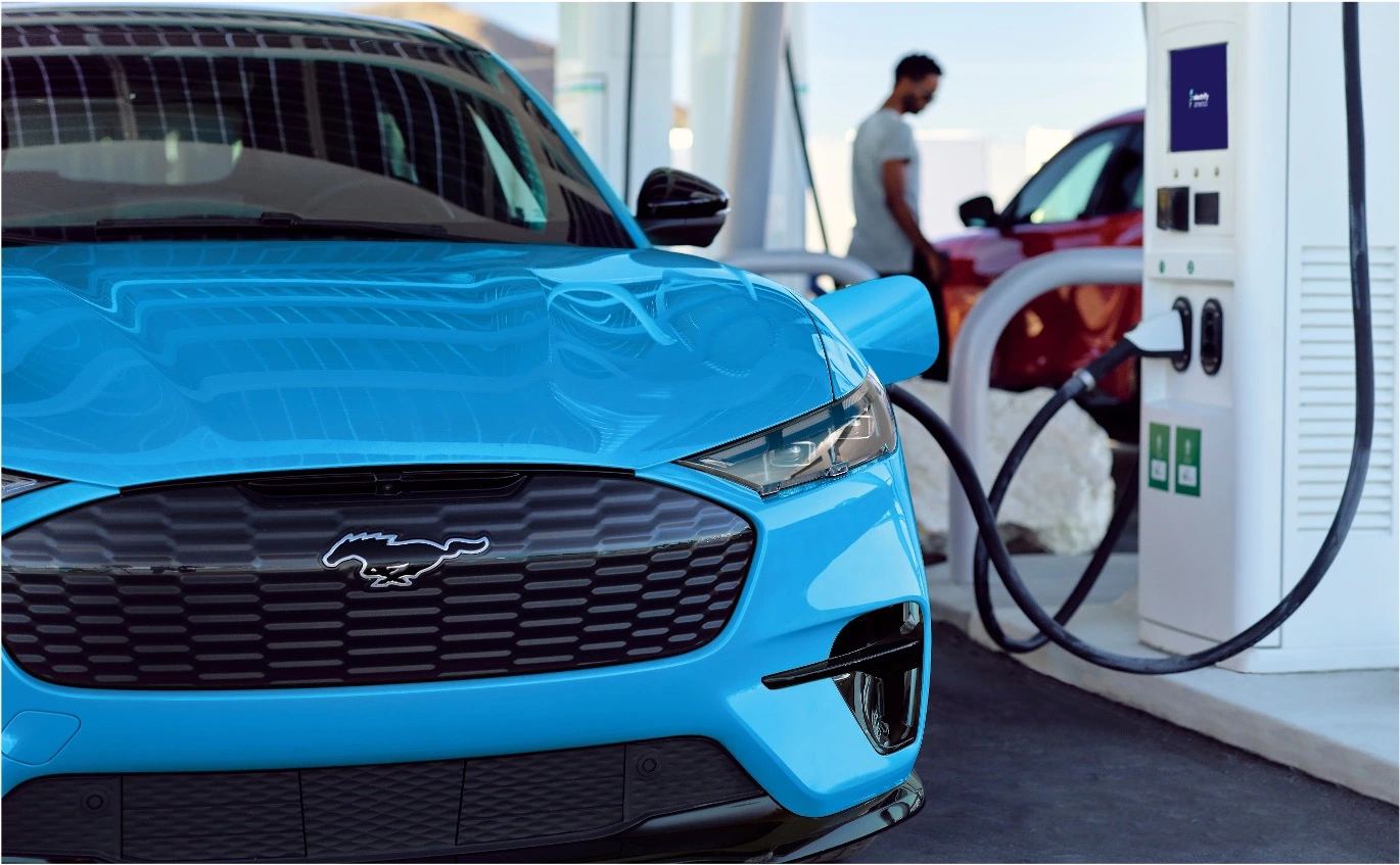 Mach-E plugged in and charging at a public charging station.